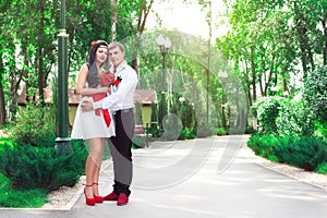 Bride and groom posing in amusement park