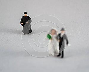 Bride, groom and priest on white