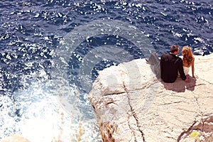 Bride and groom relaxing near water