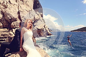 Bride and groom relaxing near water