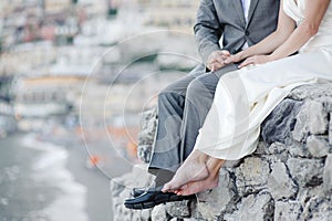 Bride and groom relaxing in wedding day in Positano, Amalfi coast
