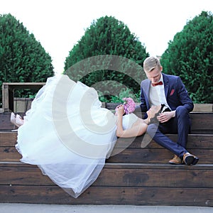 Bride and groom resting on a wooden podium