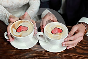 Bride and groom`s Coffee time, coffee break.Cups with hearts