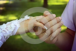 Bride and groom`s hand with golden rings