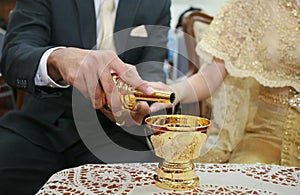 Bride and groom's hands pouring ceremonial water