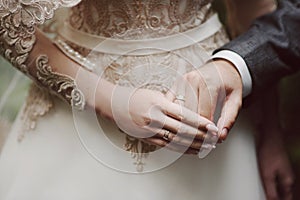 Bride and groom`s hands with wedding rings