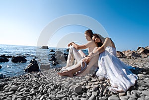 Bride and groom on sea coast photo