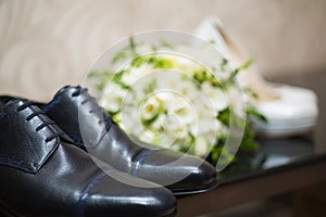 Bride and groom shoes and wedding bouquet. Close up. Wedding background