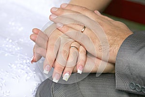 Bride and groom show their hands wearing wedding rings