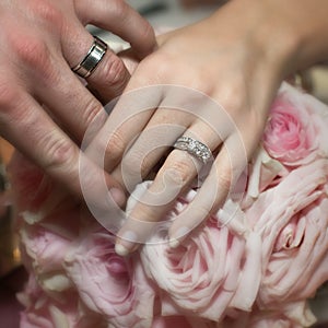 Bride and groom showing off their rings