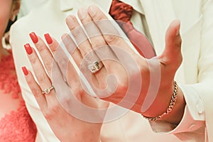 Bride and groom showing their diamond wedding rings in wedding ceremony