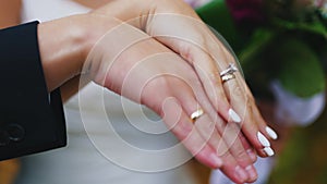 Bride and groom showing their wedding rings newly wed bride and groom photoshoot