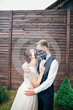 Bride and groom with a sign just married . sweet wedding details on the wedding day .Wedding couple