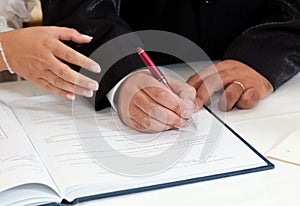 Bride and Groom Signing Marriage Certificate