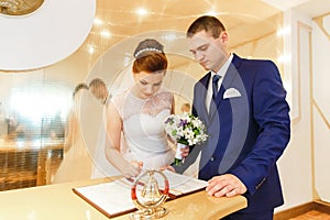 Bride and groom signing marriage license