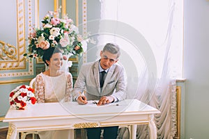 Bride and groom signing marriage license