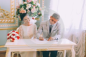 Bride and groom signing marriage license