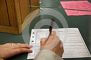 Bride and Groom signing marriage license certificate document at town hall wedding ceremony