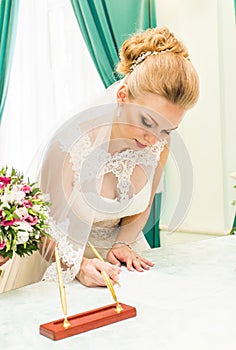 Bride and groom signing marriage license or wedding contract