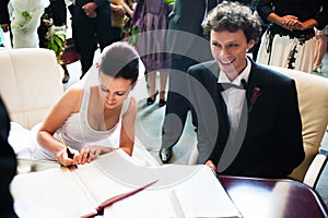 Bride and groom signing registry photo