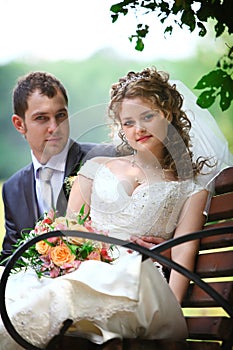 Bride and groom sitting on the bench
