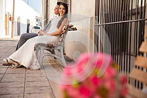 Bride and groom sitting on a bench