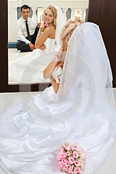 Bride and groom sitting on the floor.