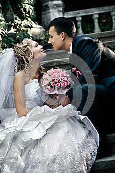 Bride and groom sitting on the stair. photo