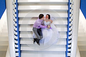 Bride and groom sitting on the stairs