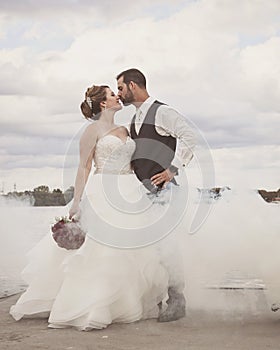 Bride and Groom standing on dock