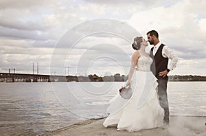 Bride and Groom standing on dock