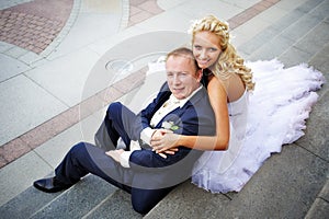 Bride and groom on steps of palace