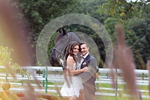 Bride and groom at stud black horse