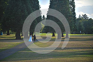 Bride and groom on a sunlit lawn