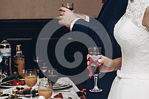 Bride and groom toasting with champagne at wedding reception in