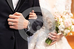 Bride and groom together, and holding the wedding bouquet