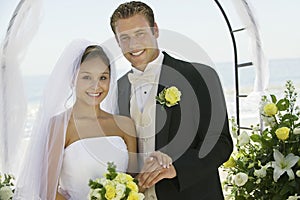 Bride and Groom under archway outdoors (portrait)