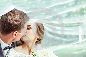 Bride and groom under the veil