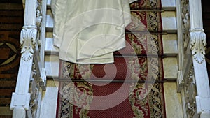 Bride and groom upping the stairs