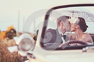 Bride and groom in a vintage car