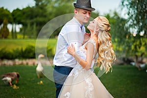 The bride and groom on a walk in the summer. Newlyweds in the park. Summer wedding in nature, Ukraine, Dnipro