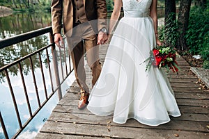 Bride and groom are walking and holding hands