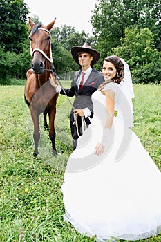 Bride groom walking a horse
