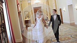 Bride and groom walking in palace