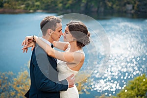 Bride and groom walking at the river