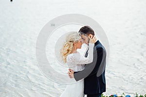 Bride and groom walking at the river