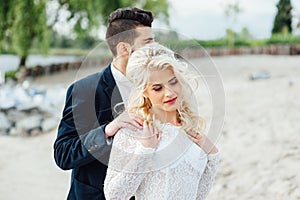 Bride and groom walking at the river