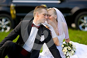 Bride and groom on wedding car background