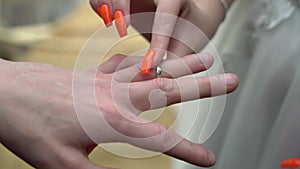 Bride and groom at wedding ceremony. Man put on a ring on a woman finger.