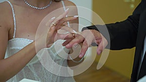 Bride and groom at wedding ceremony. Man put on a ring on a woman finger.